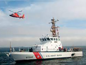 Coast Guard boat with a helicopter hovering above